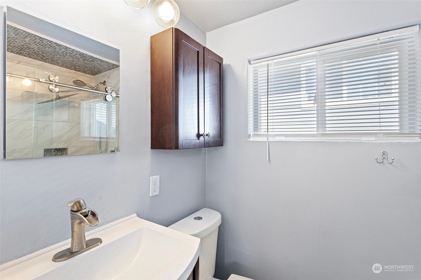 3509 Northeast 6th Street Renton, WA 98056 - Photo 17 of 26 a bathroom with a sink a toilet and a mirror