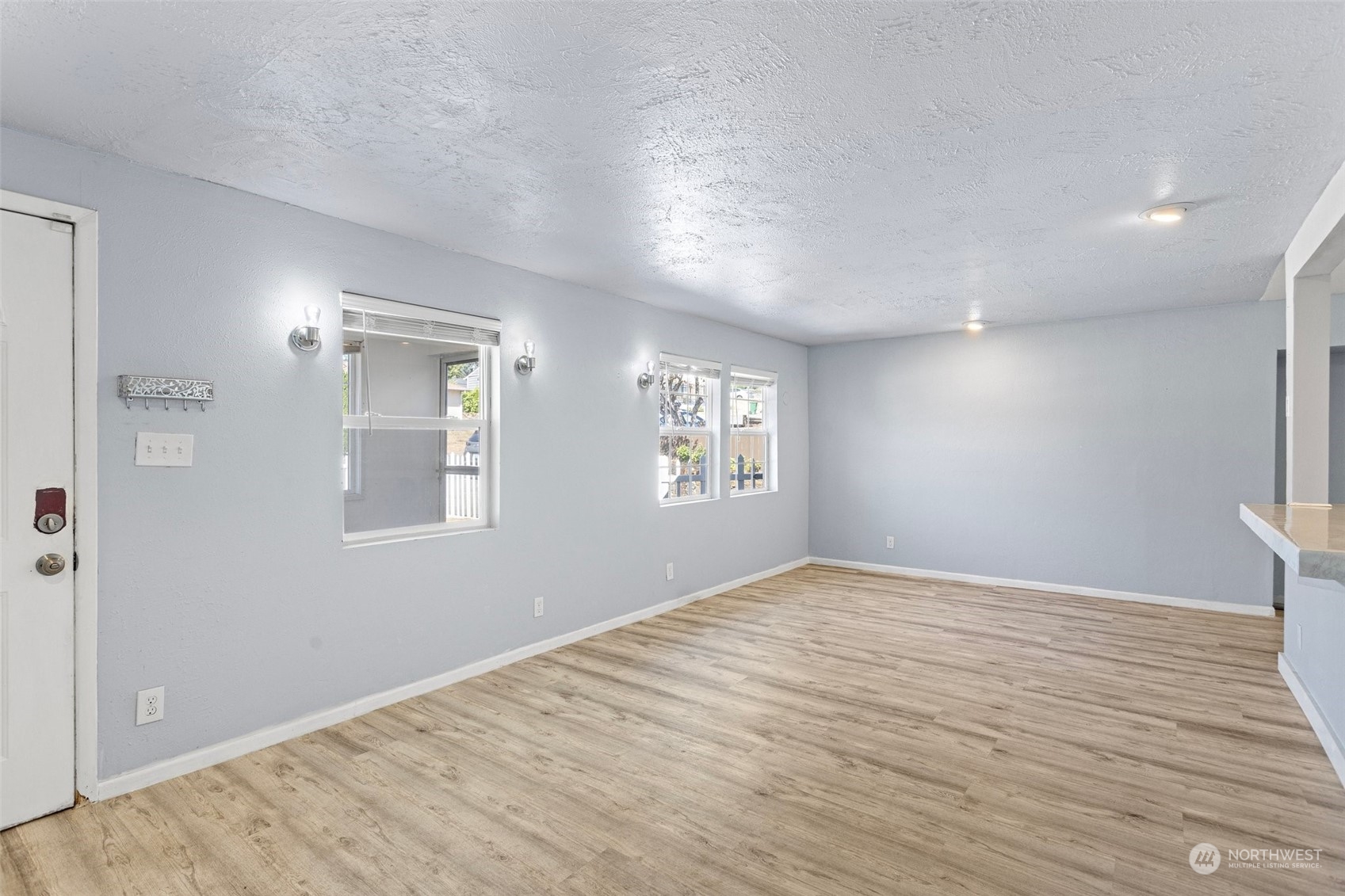 3509 Northeast 6th Street Renton, WA 98056 - Photo 4 of 26 a view of empty room with wooden floor and fan