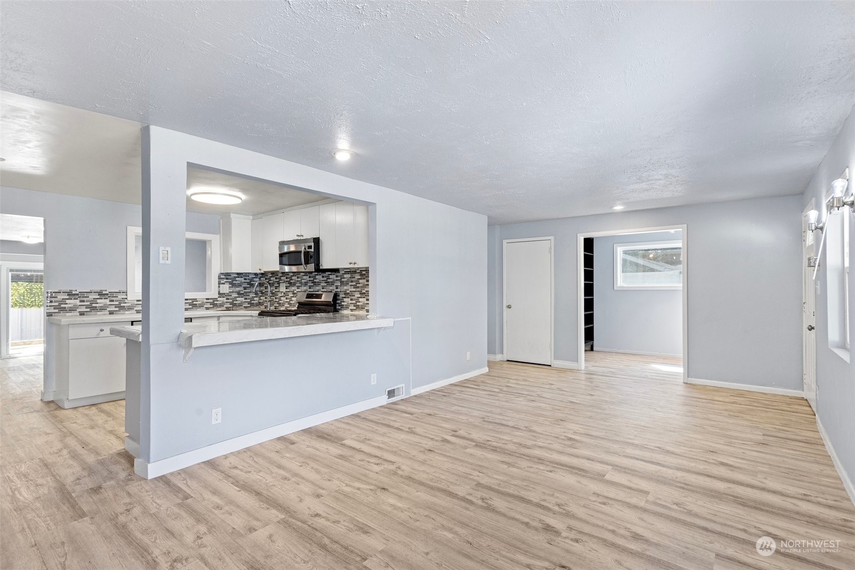 3509 Northeast 6th Street Renton, WA 98056 - Photo 5 of 26 a view of a kitchen cabinets and wooden floor