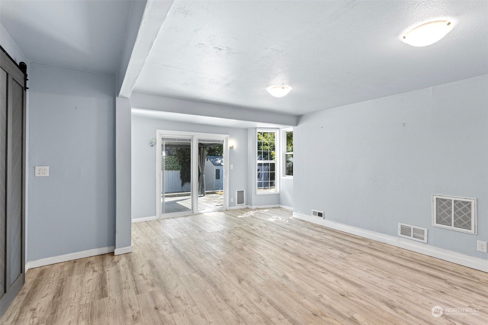 3509 Northeast 6th Street Renton, WA 98056 - Photo 9 of 26 a view of an empty room with wooden floor and a window