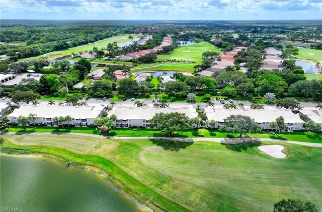 a view of a town with large trees and houses