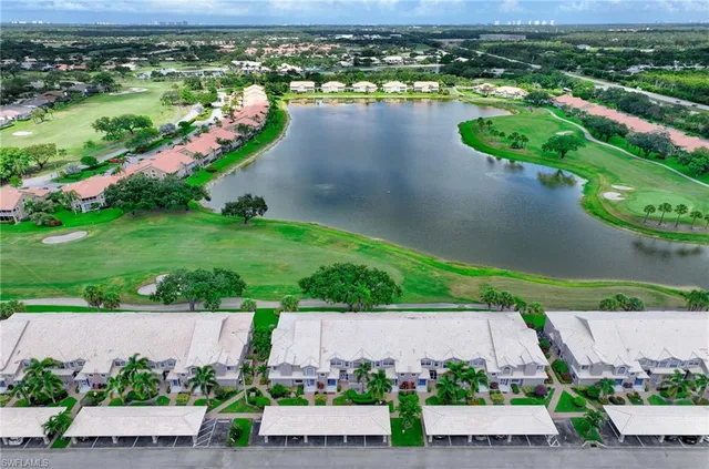 an aerial view of a house with a garden and lake view