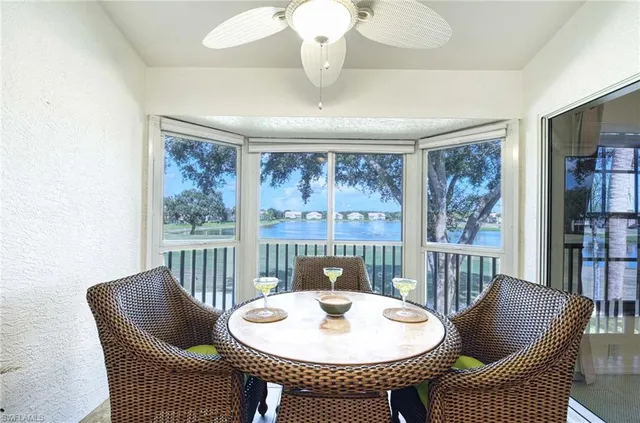 a dining room with furniture a rug and a large window