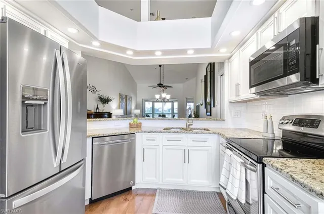 a kitchen with a sink stove and microwave