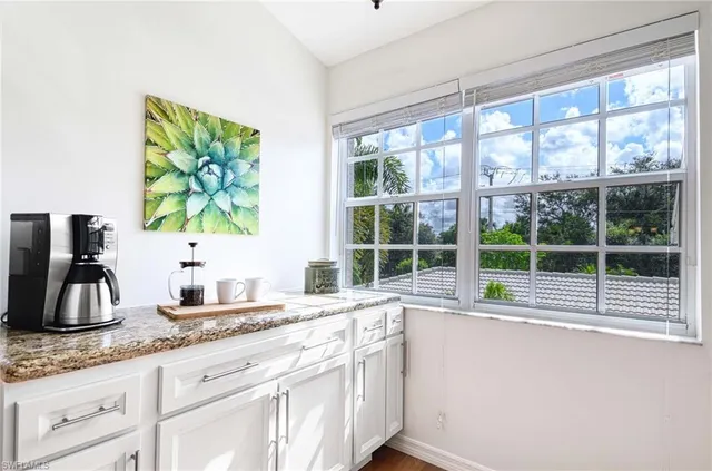a kitchen with sink and large window