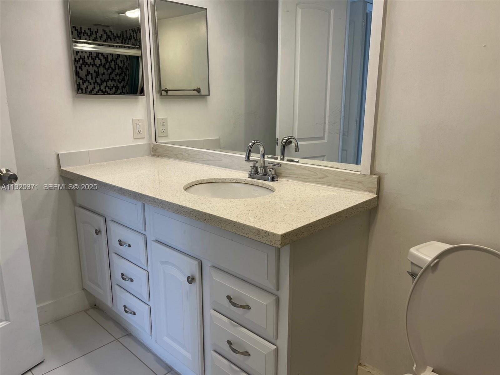 3100 North Palm Aire Drive, Unit 104 Pompano Beach, FL 33069 - Photo 11 of 20 a bathroom with a sink and a mirror