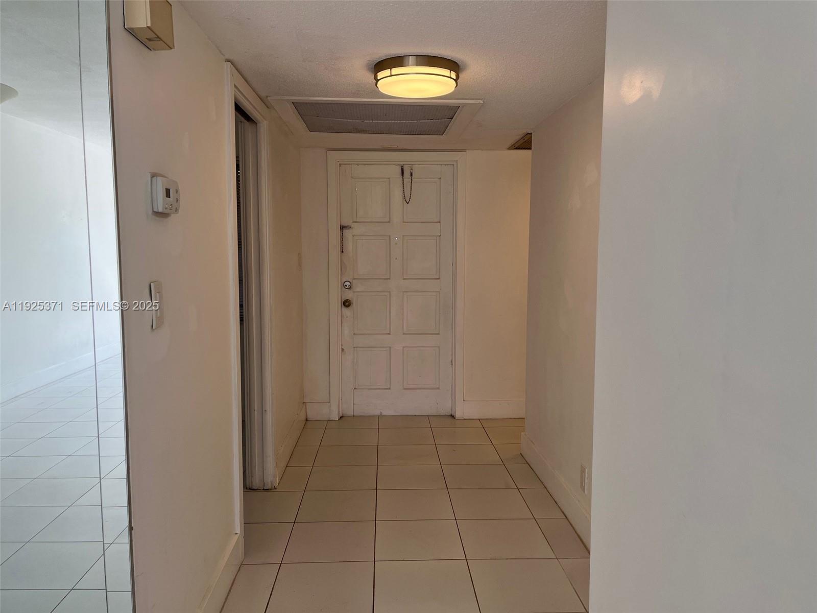 3100 North Palm Aire Drive, Unit 104 Pompano Beach, FL 33069 - Photo 19 of 20 a view of a hallway with a door
