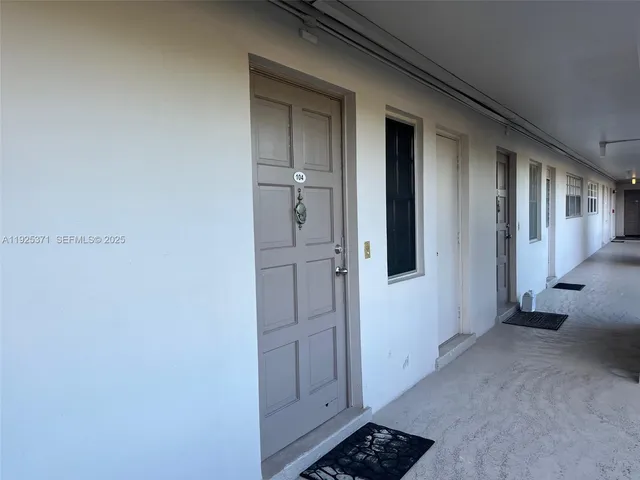 a view of a hallway with closet and wooden floor