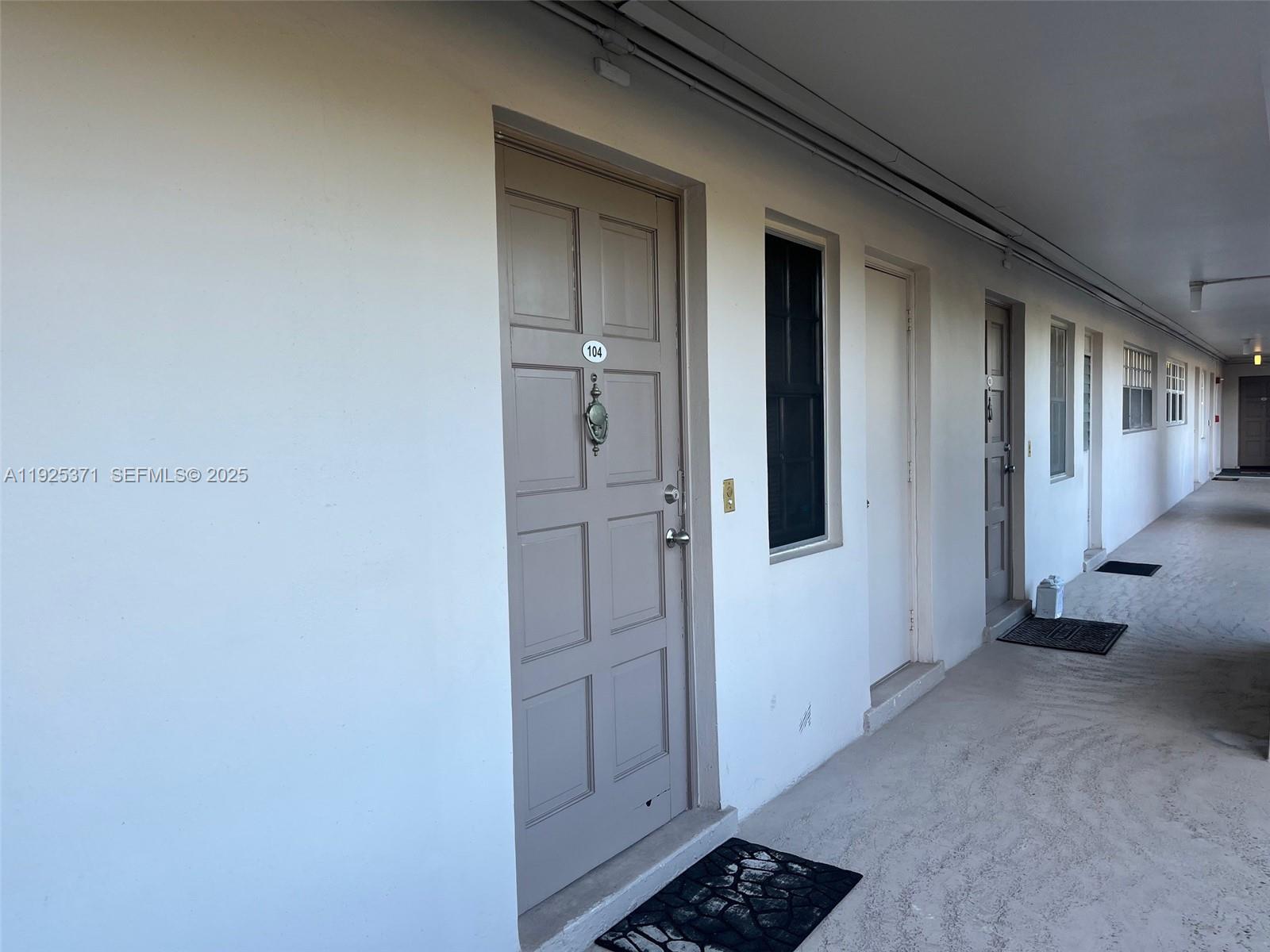 3100 North Palm Aire Drive, Unit 104 Pompano Beach, FL 33069 - Photo 6 of 20 a view of a hallway with closet and wooden floor