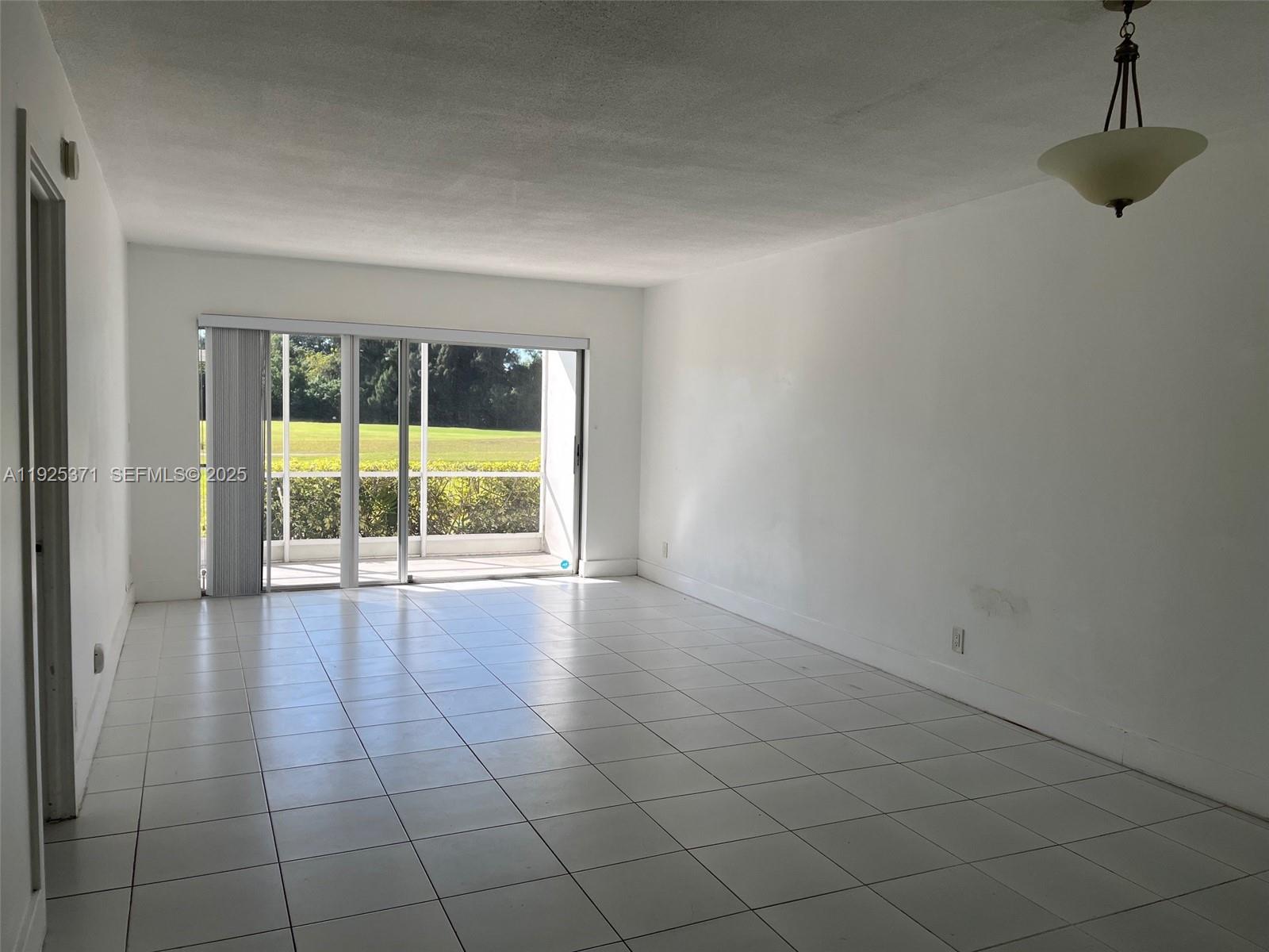 3100 North Palm Aire Drive, Unit 104 Pompano Beach, FL 33069 - Photo 7 of 20 a view of an empty room with a window