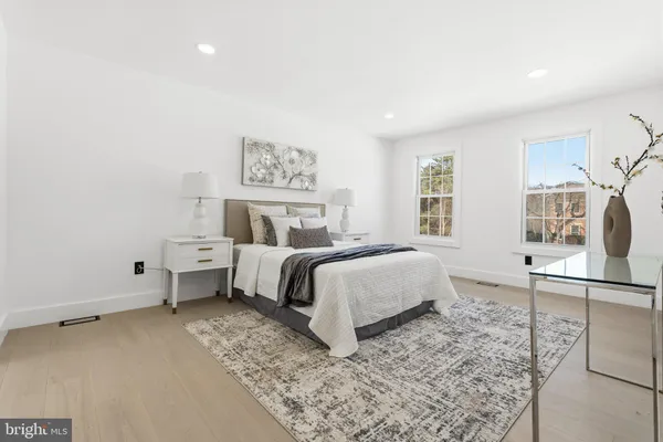 a bedroom with a bed and glass windows