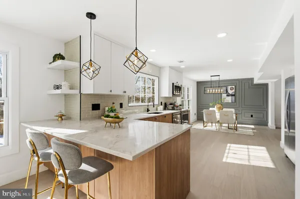 a kitchen with stainless steel appliances kitchen island granite countertop a sink and cabinets
