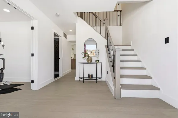 a view of a hallway with entryway wooden floor and front door