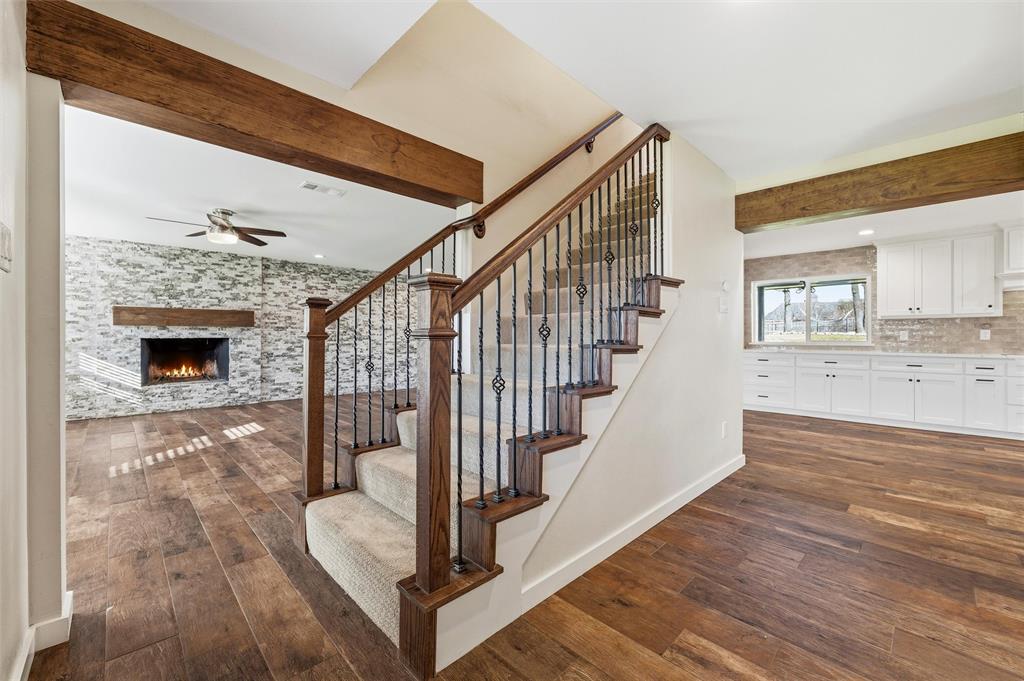 a living room with wooden floor and a fireplace