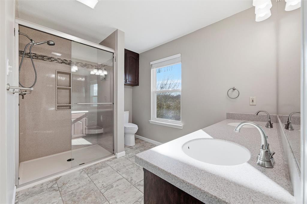 1845 Summer Lane Keller, TX 76262 - Photo 19 of 28 a bathroom with a sink a toilet and shower