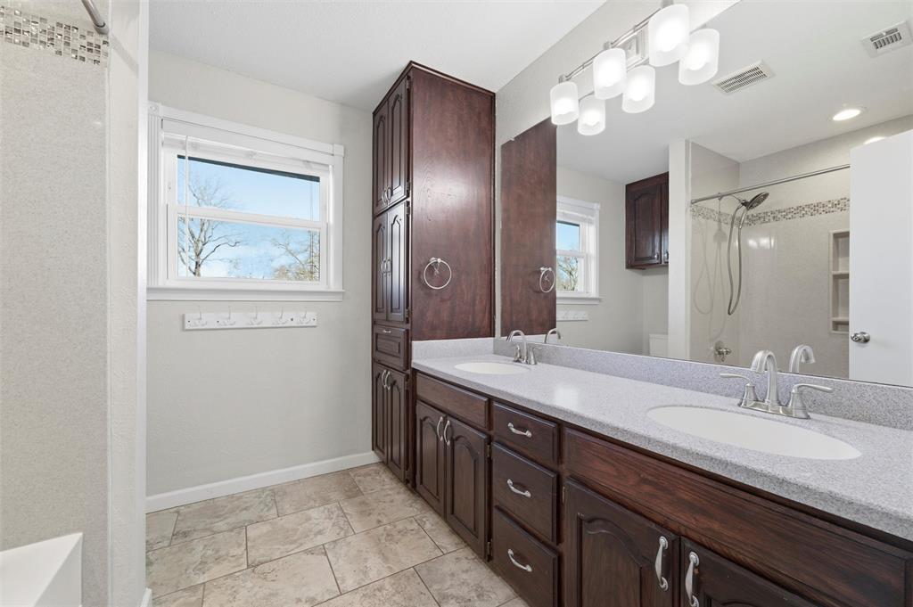1845 Summer Lane Keller, TX 76262 - Photo 21 of 28 a bathroom with a granite countertop sink a light fixture and a mirror