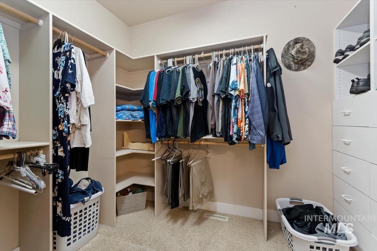 10462 West Lanktree Gulch Road Star, ID 83669 - Photo 22 of 48 Custom-built walk-in closet featuring extensive shelving, multiple hanging rods, corner shelving units, and integrated drawer storage
