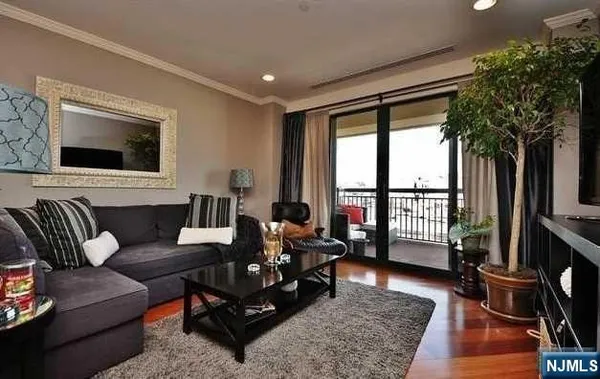 a living room with furniture tv and a floor to ceiling window
