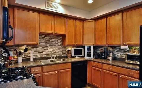 a kitchen with stainless steel appliances wooden cabinets and a counter top space