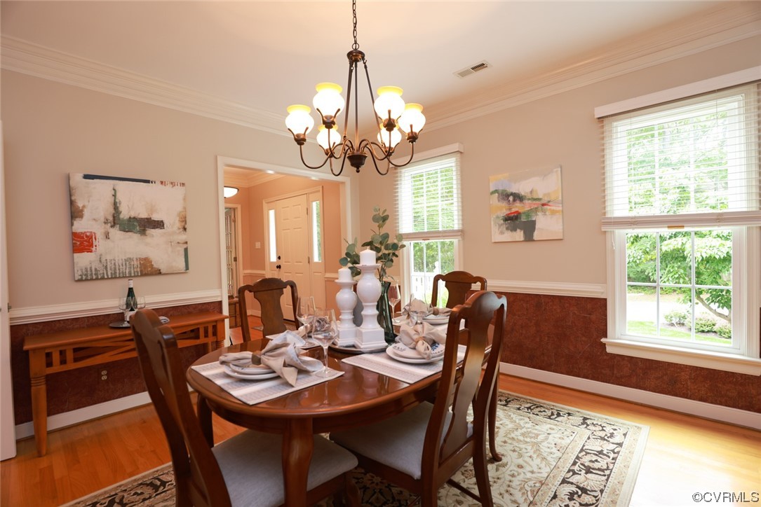 6314 Walnut Bend Drive Midlothian, VA 23112 - Photo 4 of 50 a view of a dining room with furniture a chandelier and wooden floor
