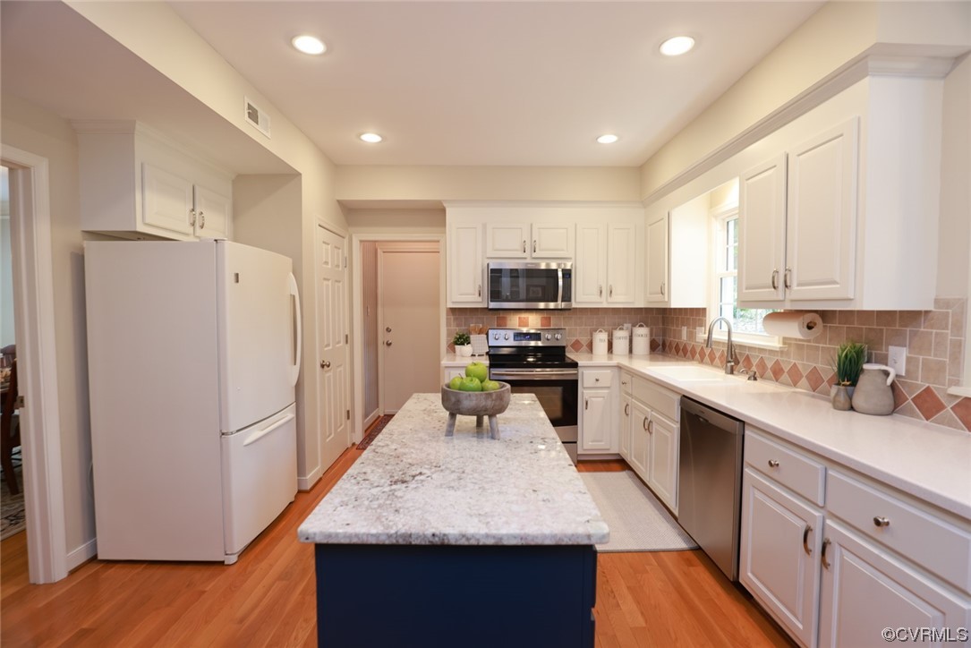 6314 Walnut Bend Drive Midlothian, VA 23112 - Photo 6 of 50 a kitchen with refrigerator cabinets and wooden floor