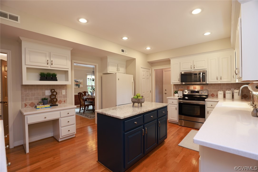 6314 Walnut Bend Drive Midlothian, VA 23112 - Photo 8 of 50 a kitchen with stainless steel appliances kitchen island granite countertop a stove top oven a sink a refrigerator and white cabinets with wooden floor