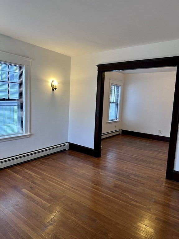289 Highland Avenue, Unit 1L Quincy, MA 02170 - Photo 2 of 5 a view of a room with wooden floor and window
