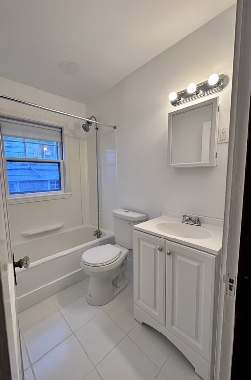 289 Highland Avenue, Unit 1L Quincy, MA 02170 - Photo 5 of 5 a bathroom with a sink a toilet and shower