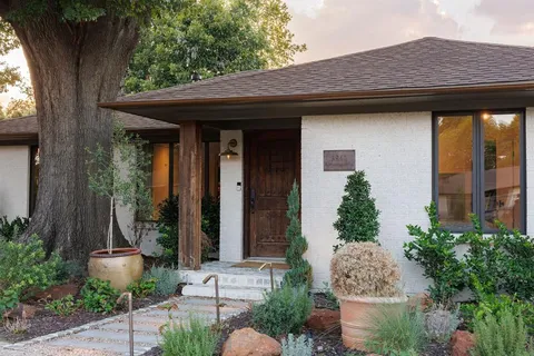 a front view of a house with garden
