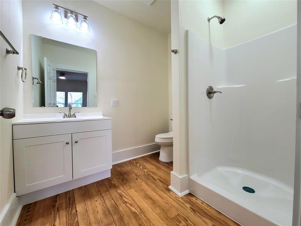 110 West Morton Street Denison, TX 75021 - Photo 12 of 15 a bathroom with a sink a toilet and shower