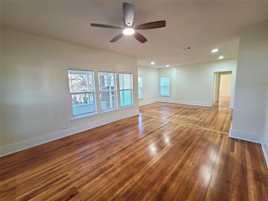 110 West Morton Street Denison, TX 75021 - Photo 3 of 15 a view of an empty room with wooden floor and a window