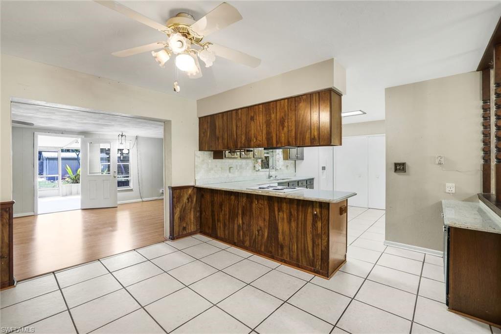 5290 Cypress Lane Naples, FL 34113 - Photo 14 of 39 a kitchen with stainless steel appliances a sink stove and cabinets