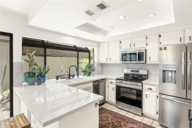a kitchen with a stove a sink and a refrigerator