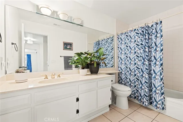 a bathroom with a sink toilet and a mirror