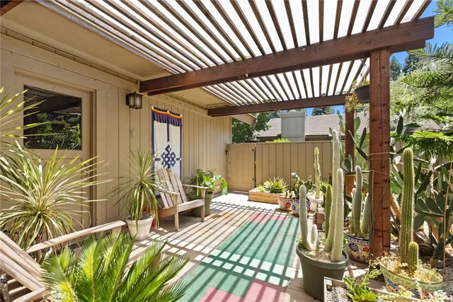 a view of a patio with table and chairs with wooden floor and fence