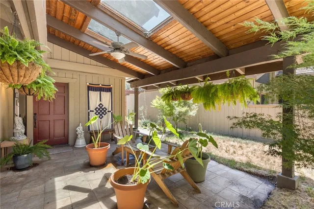 a view of a porch with potted plants