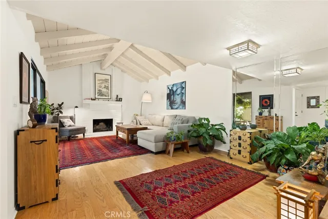 a living room with furniture fireplace and potted plant