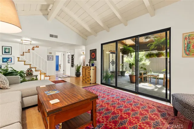 a living room with furniture a rug and a large window