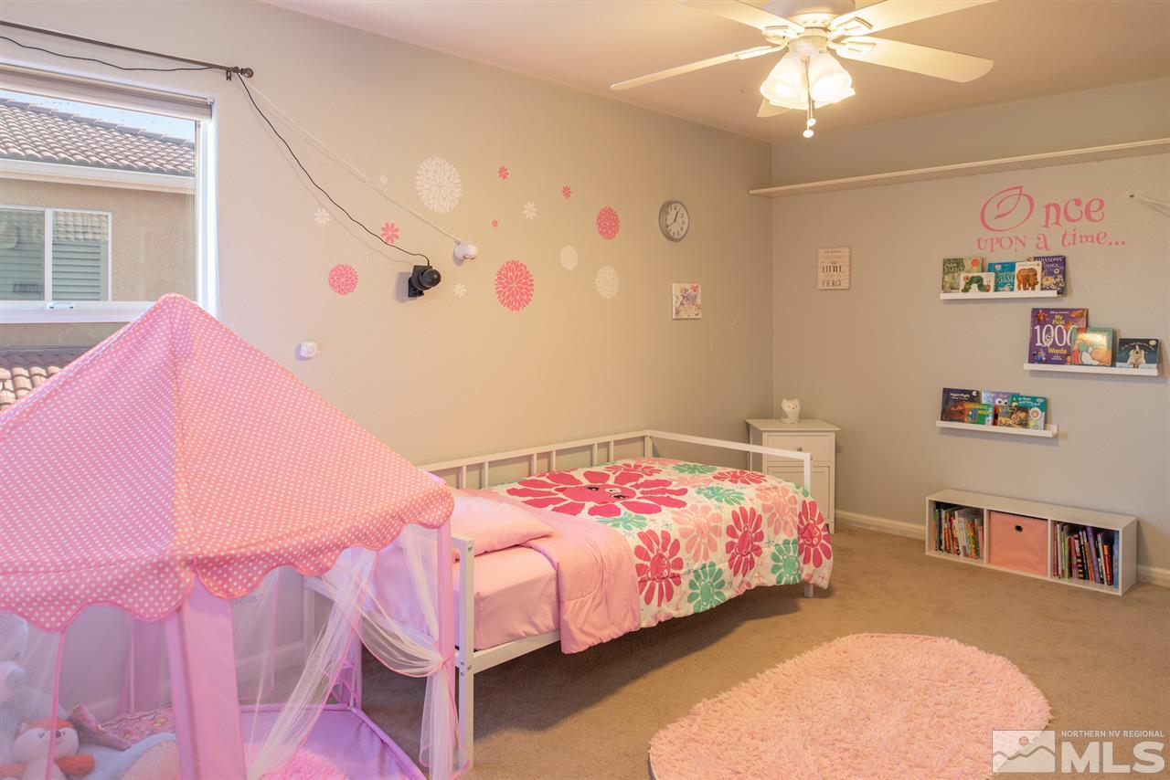 435 Sondrio Court Reno, NV 89521 - Photo 14 of 25 a bedroom with a bed and a chandelier