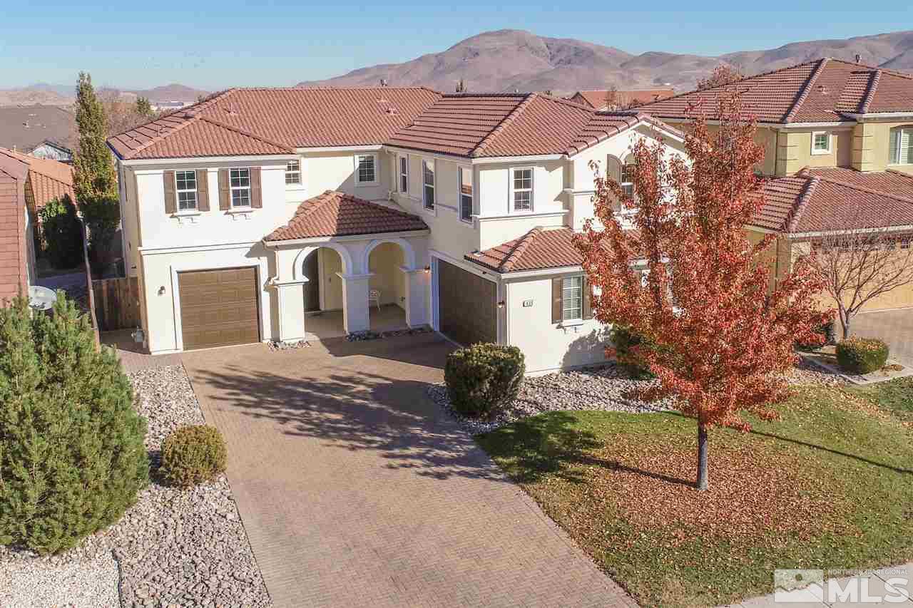 435 Sondrio Court Reno, NV 89521 - Photo 3 of 25 a view of a white house next to a yard with road and plants