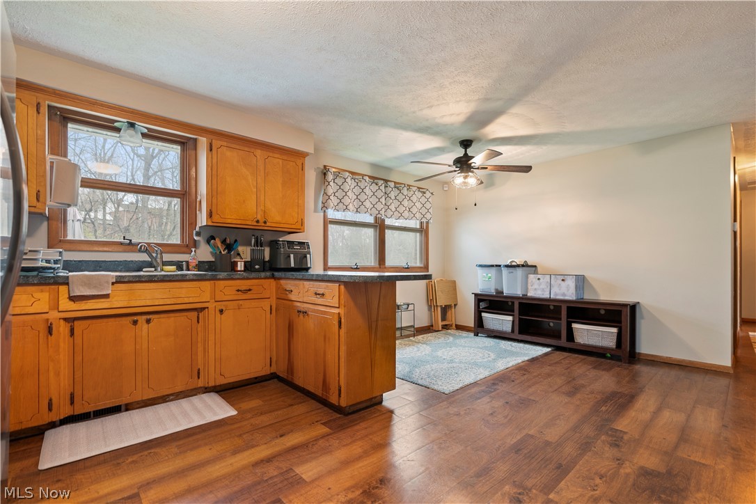 4904 3rd Street Northwest Canton, OH 44708 - Photo 13 of 31 Kitchen featuring dark hardwood / wood-style flooring, ceiling fan, and a textured ceiling