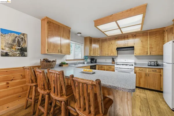 a kitchen with a sink and breakfast area