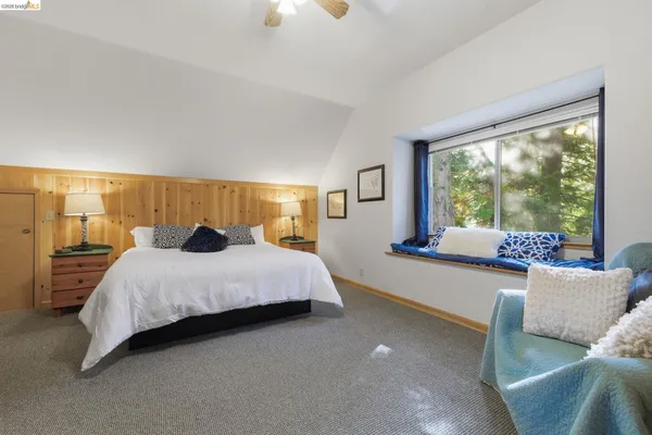 a bedroom with a bed and window