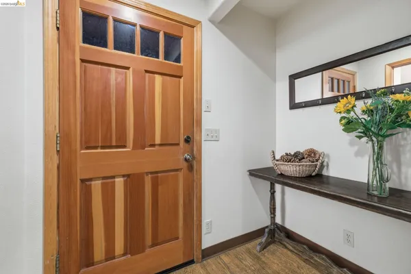 a living room with furniture a large window and a fireplace