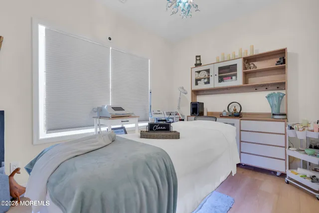 a bedroom with a bed and a night stand