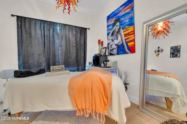 a bedroom with a bed and painting on the wall