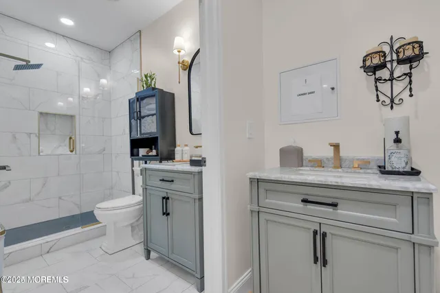 a spacious bathroom with a toilet sink and mirror