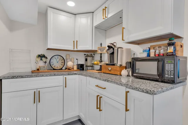 a kitchen with stainless steel appliances granite countertop a sink and cabinets