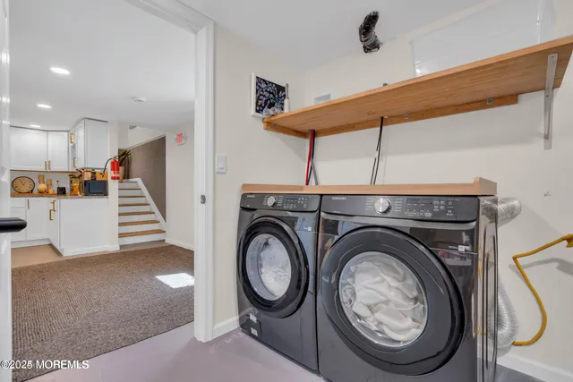 a view of a storage & utility room with a washer dryer