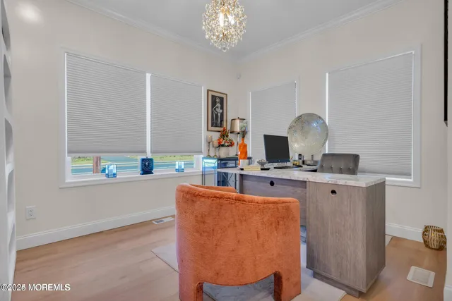 a living room with furniture a chandelier and a window